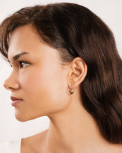 Load image into Gallery viewer, Woman with styled hair and earring on a white background
