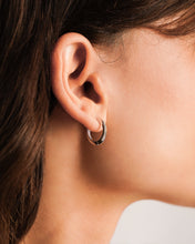 Load image into Gallery viewer, Close-up of a person wearing a white gold hoop earring.

